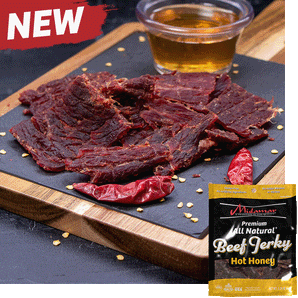 Midamar halal beef jerky strips sit on a cutting board surrounded by dried peppers and seeds, behind the jerky is a clear cup of honey overlayed is a picture of the package