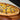 Midamar halal seasoned beef topping cooked into a pizza, the pizza rests on a round wooden tray