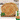 4 paratha are resting in a small wooden tray. There is a garnish of a green leaves in the box, in the bottom right hand corner is an image of the product box